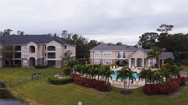 exterior space with a yard, a patio area, and a community pool