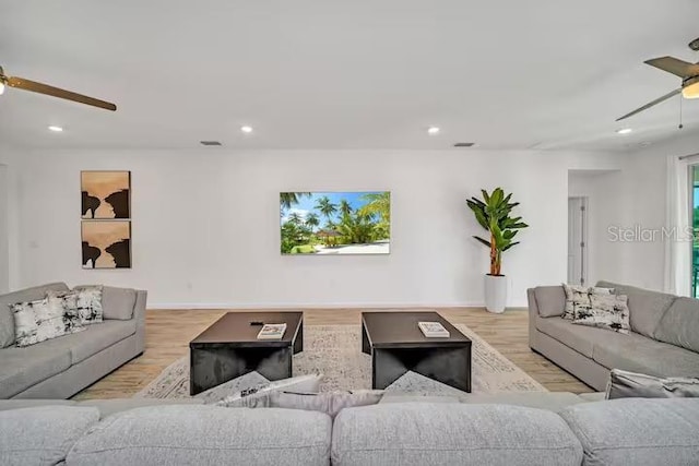 living room with ceiling fan and light hardwood / wood-style floors