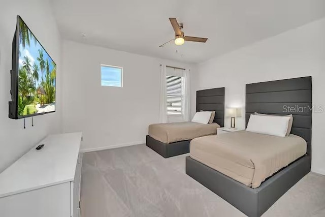 bedroom featuring ceiling fan and light colored carpet