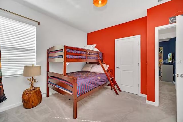 bedroom featuring light carpet