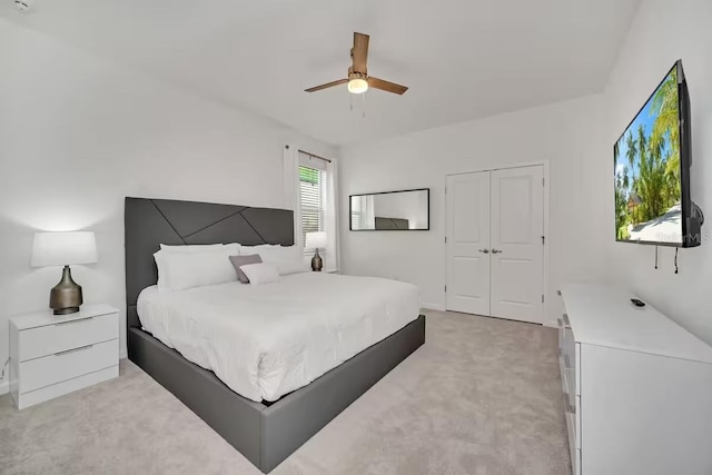 carpeted bedroom featuring ceiling fan and a closet