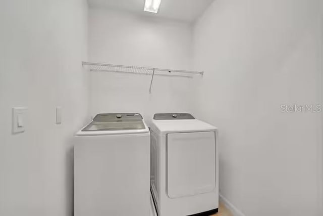 clothes washing area featuring washing machine and clothes dryer