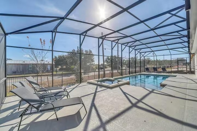 view of swimming pool featuring a patio area, a lanai, and an in ground hot tub