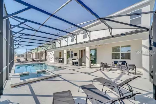 view of pool with glass enclosure, a patio area, and an in ground hot tub