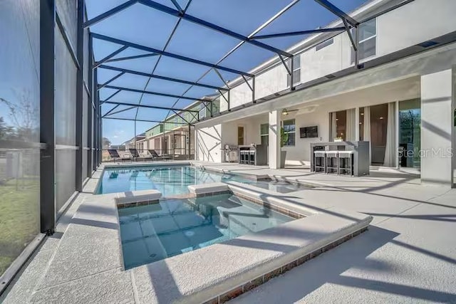 view of swimming pool featuring an in ground hot tub, a bar, a patio, and glass enclosure