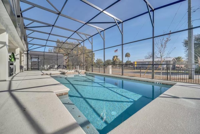 view of swimming pool featuring a lanai and a patio