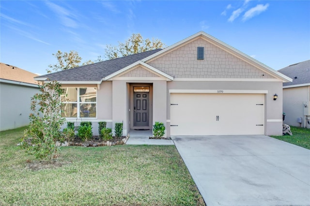 view of front of property with a garage and a front lawn