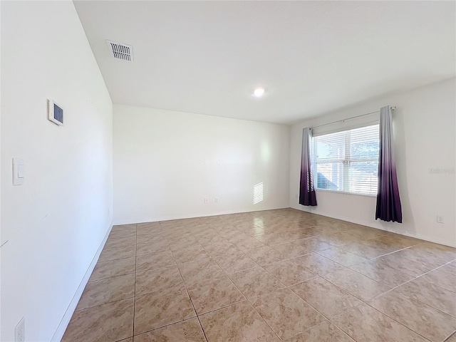 unfurnished room with light tile patterned floors