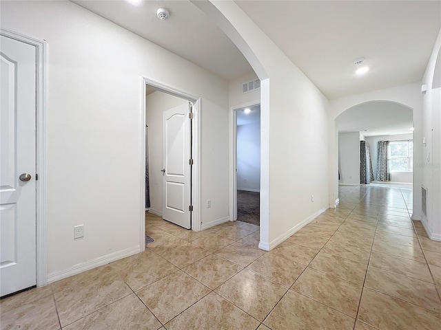 corridor featuring light tile patterned floors