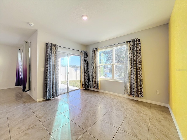 spare room with light tile patterned floors