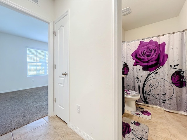 bathroom with tile patterned floors and toilet