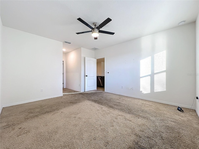 carpeted spare room with ceiling fan