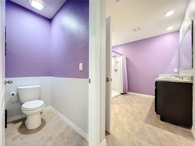 bathroom featuring a shower with shower curtain, tile patterned floors, vanity, and toilet