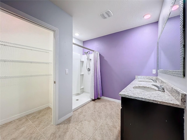 bathroom with tile patterned floors, a shower with curtain, and vanity