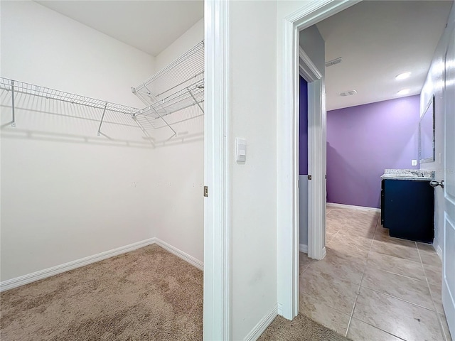 spacious closet with carpet flooring