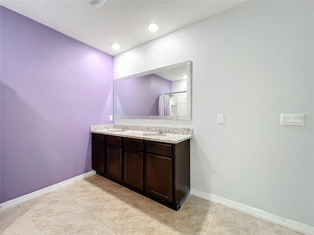 bathroom featuring vanity, tile patterned floors, and curtained shower