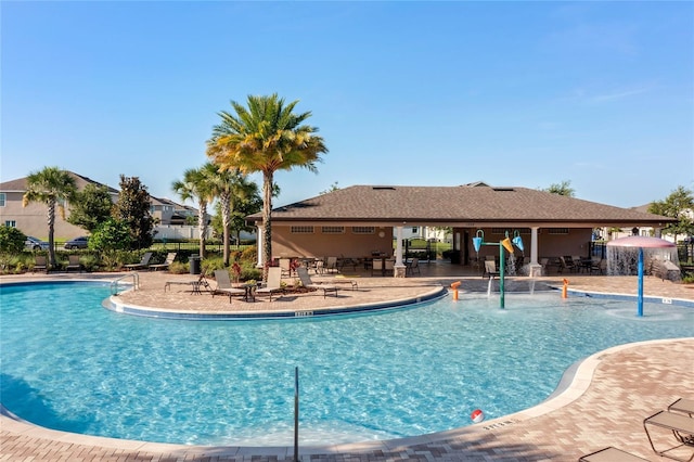 view of pool with pool water feature and a patio area