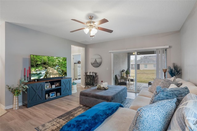 living room featuring ceiling fan and light wood-type flooring