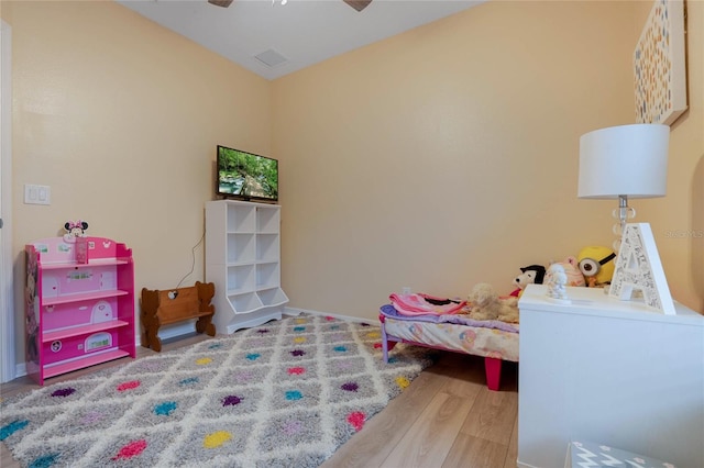 bedroom with ceiling fan and hardwood / wood-style floors