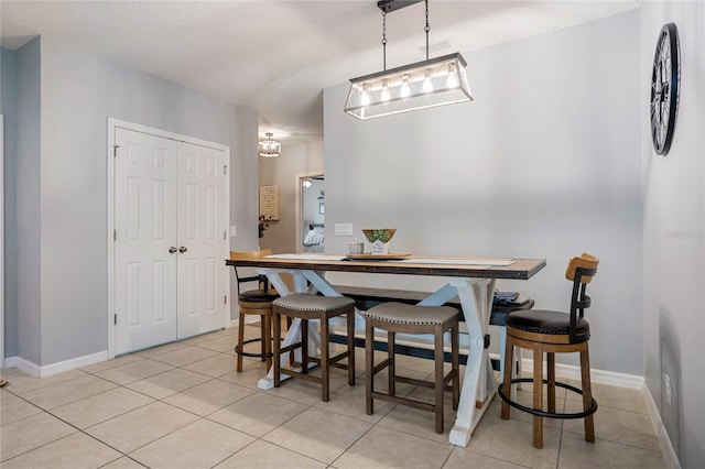 dining space featuring light tile patterned floors