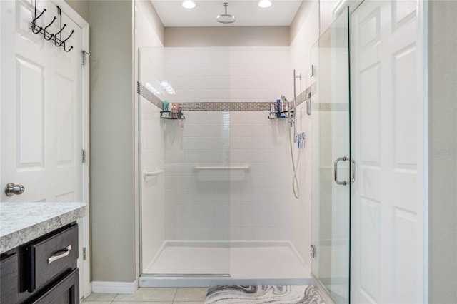 bathroom featuring vanity, an enclosed shower, and tile patterned flooring