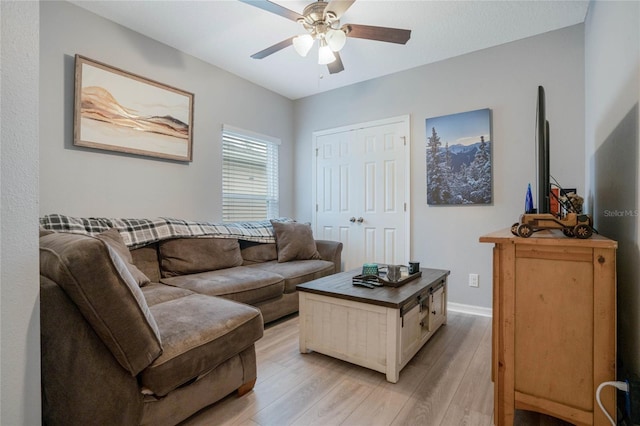 living room with ceiling fan and light hardwood / wood-style floors