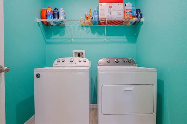 laundry area with hardwood / wood-style flooring and washing machine and dryer