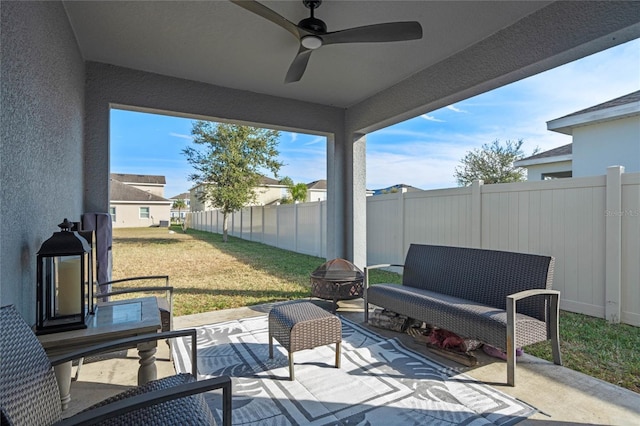 view of patio / terrace with ceiling fan and an outdoor fire pit