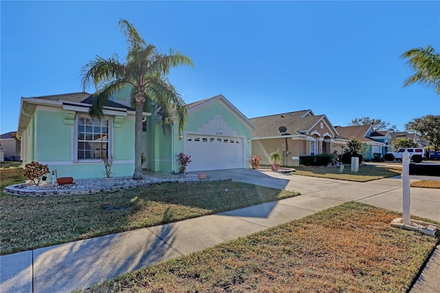 ranch-style house with a garage and a front lawn