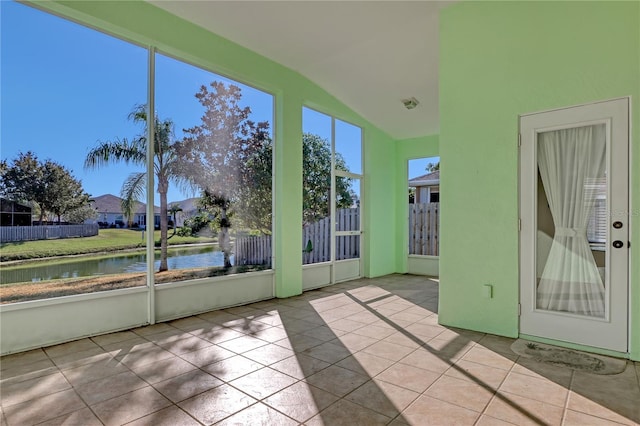 unfurnished sunroom with a water view and lofted ceiling