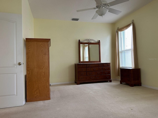 unfurnished bedroom with light colored carpet and ceiling fan