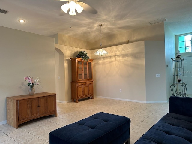 living room featuring light tile patterned floors and ceiling fan