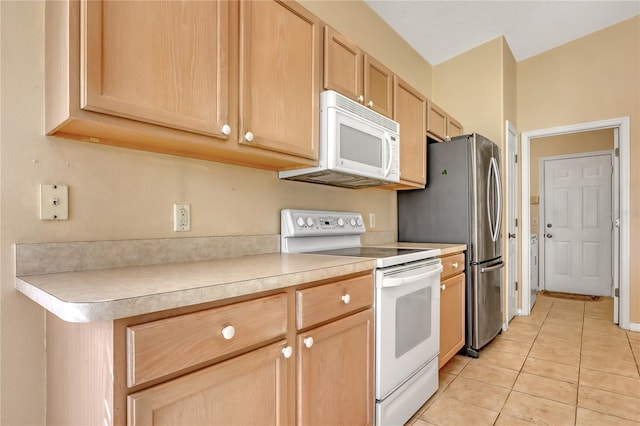 kitchen with light brown cabinets, light tile patterned floors, and white appliances