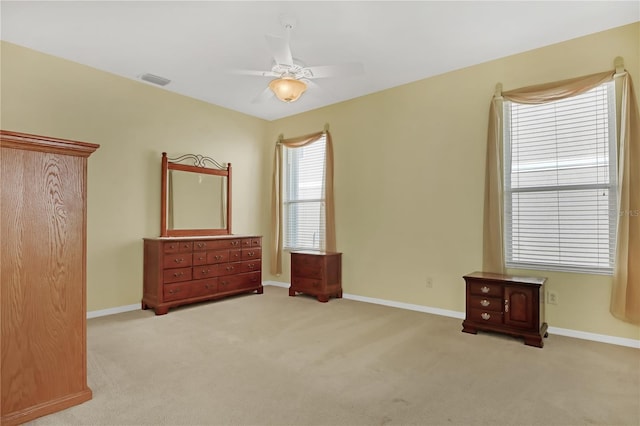 bedroom with ceiling fan and light carpet