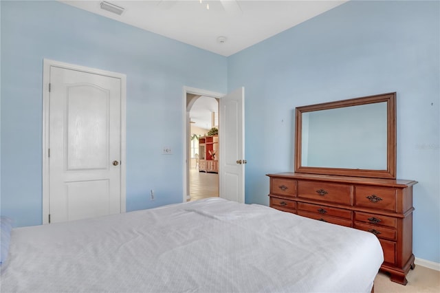 bedroom with light colored carpet and ceiling fan