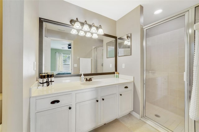 bathroom with tile patterned floors, ceiling fan, a shower with door, and vanity