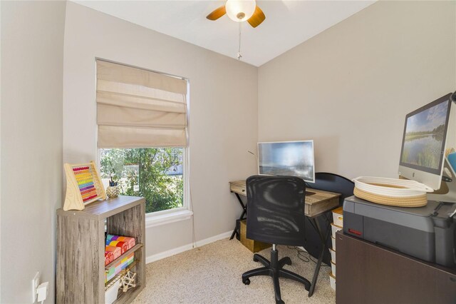 carpeted office featuring ceiling fan