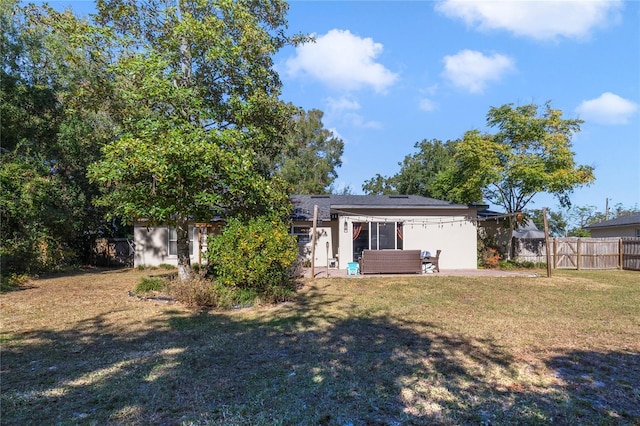 back of house featuring a lawn, a patio area, and an outdoor hangout area