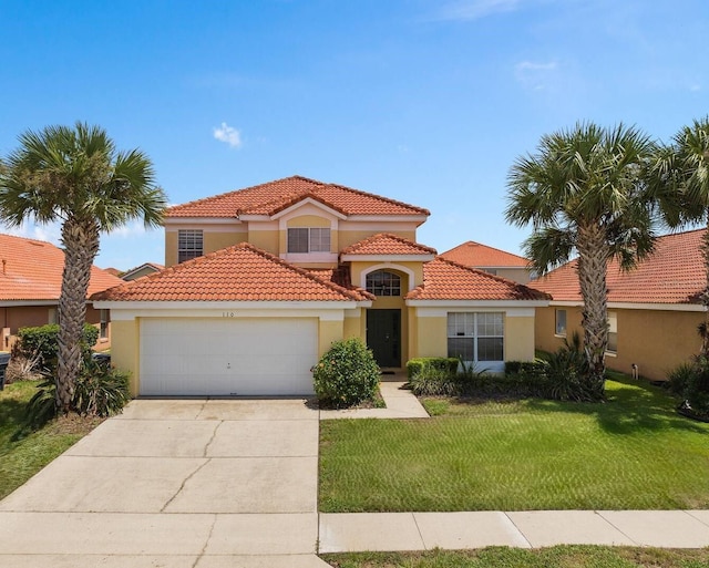 mediterranean / spanish-style home featuring a front lawn and a garage