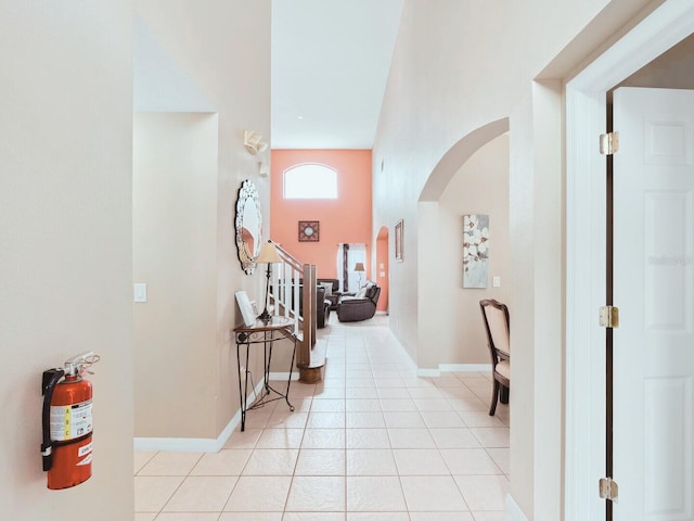 hall featuring light tile patterned flooring