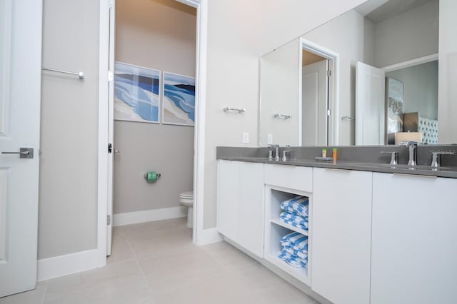 bathroom with tile patterned floors, vanity, and toilet