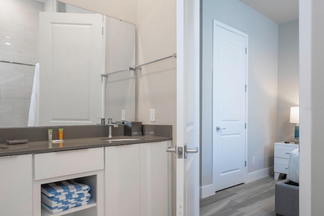 bathroom with hardwood / wood-style floors and vanity