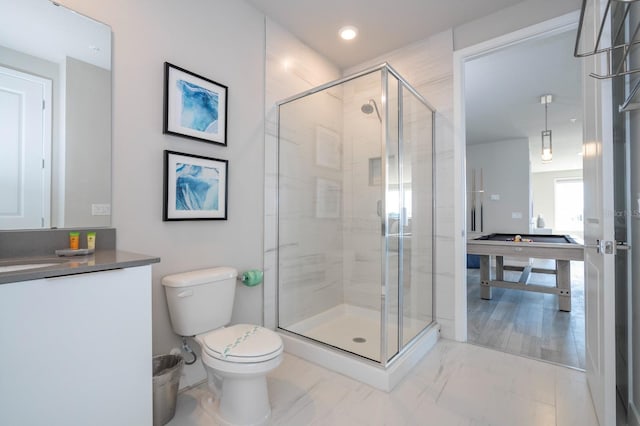 bathroom featuring vanity, toilet, a shower with door, and pool table