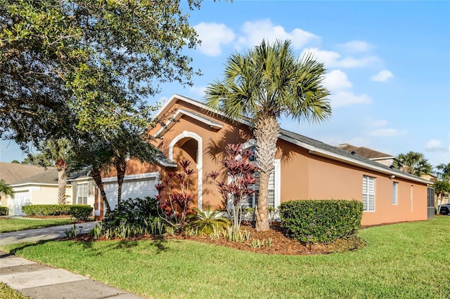 view of front of property featuring a front lawn and a garage