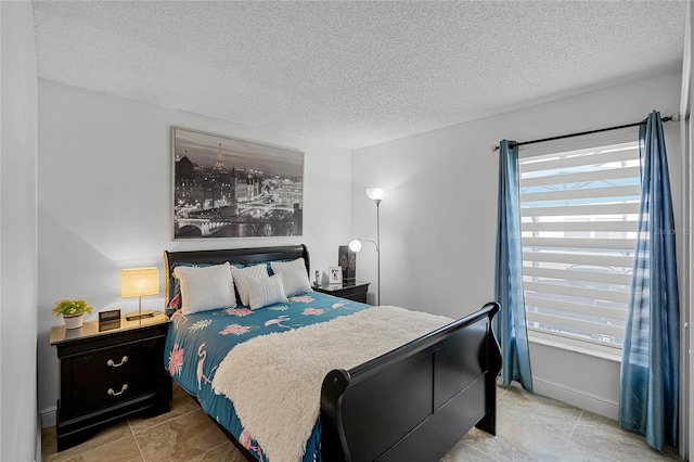 bedroom featuring multiple windows and a textured ceiling