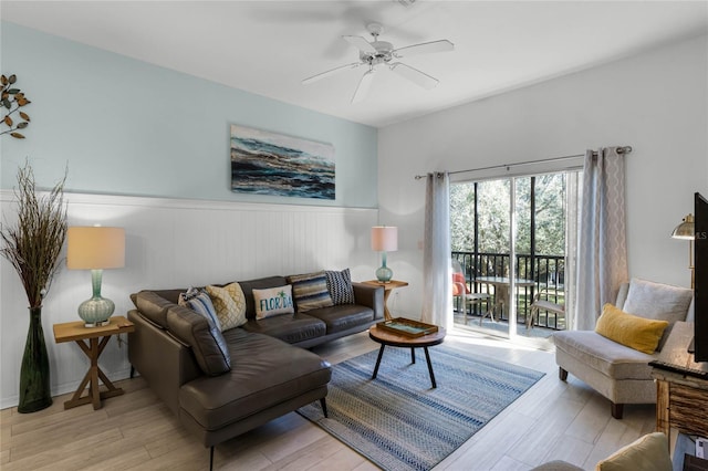 living room with ceiling fan and light hardwood / wood-style flooring