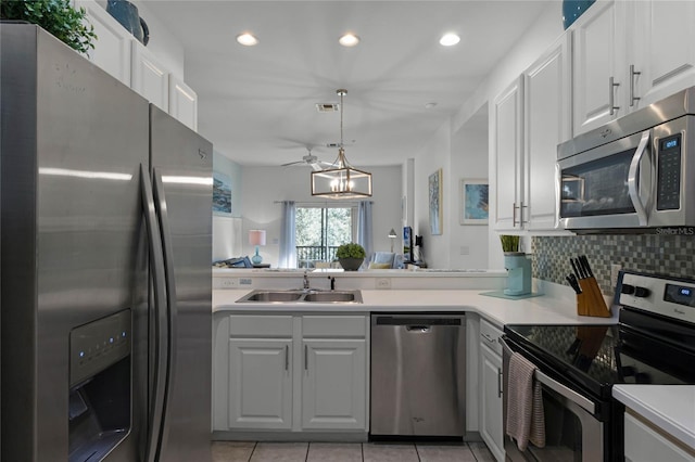 kitchen with white cabinets, light tile patterned flooring, sink, and appliances with stainless steel finishes