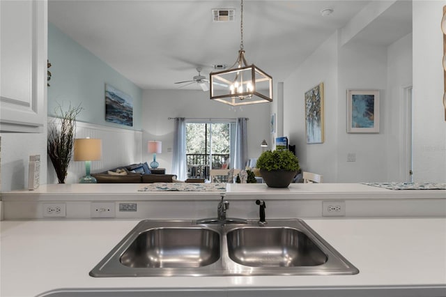 411 Lucaya Loop Unit 411, Davenport, FL 33897 - kitchen featuring open floor plan, light countertops, a sink, ceiling fan, and hanging light fixtures