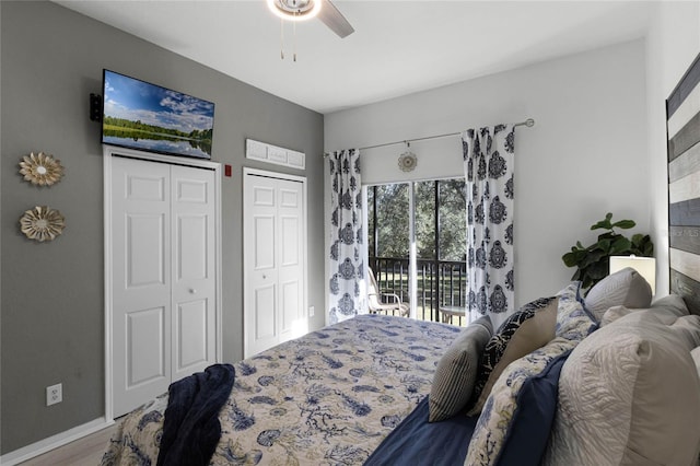 bedroom featuring access to exterior, hardwood / wood-style floors, two closets, and ceiling fan