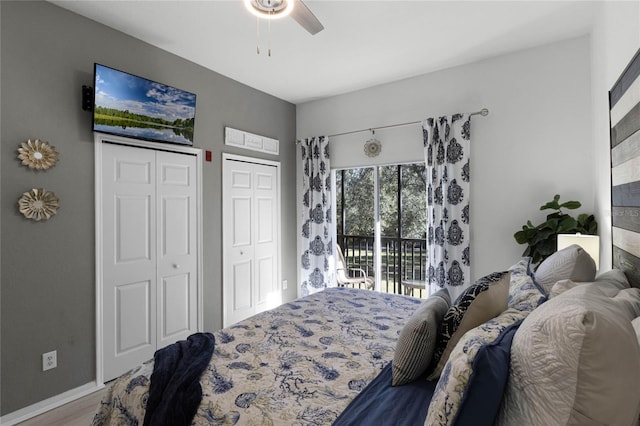 411 Lucaya Loop Unit 411, Davenport, FL 33897 - bedroom with multiple closets, access to exterior, ceiling fan, wood finished floors, and baseboards